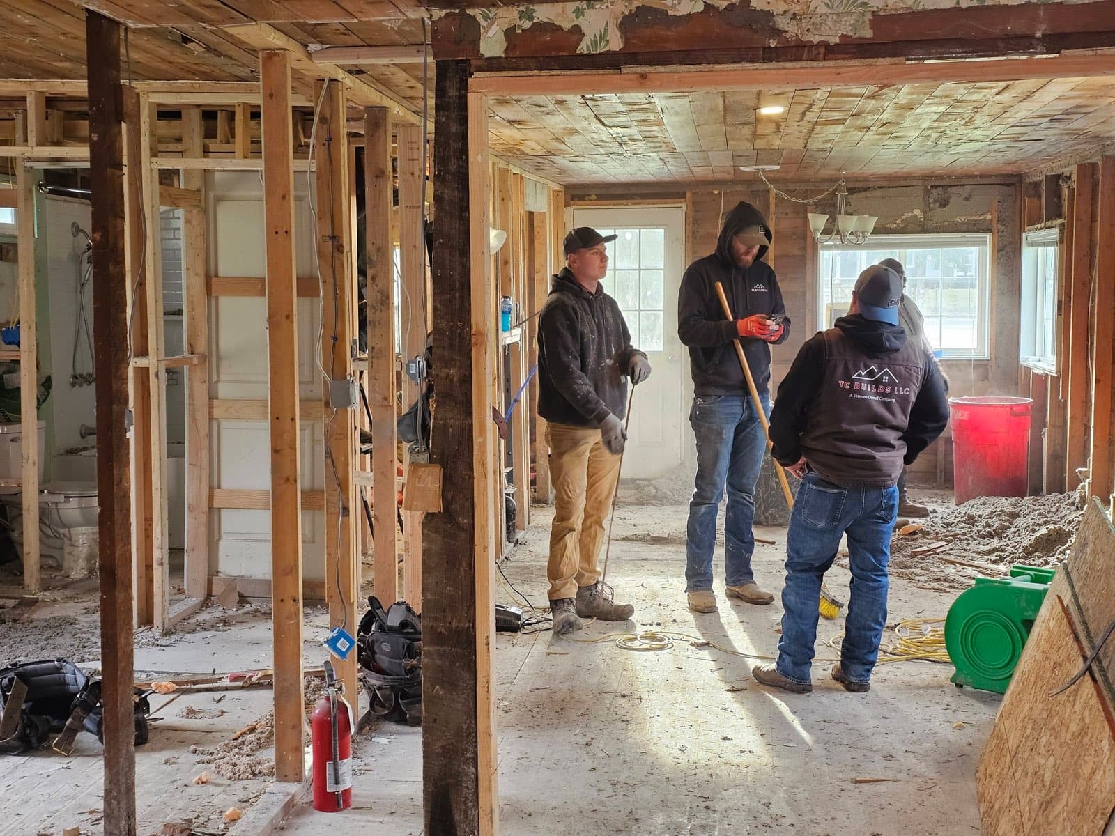 TC BUILDS team meeting inside a home under construction